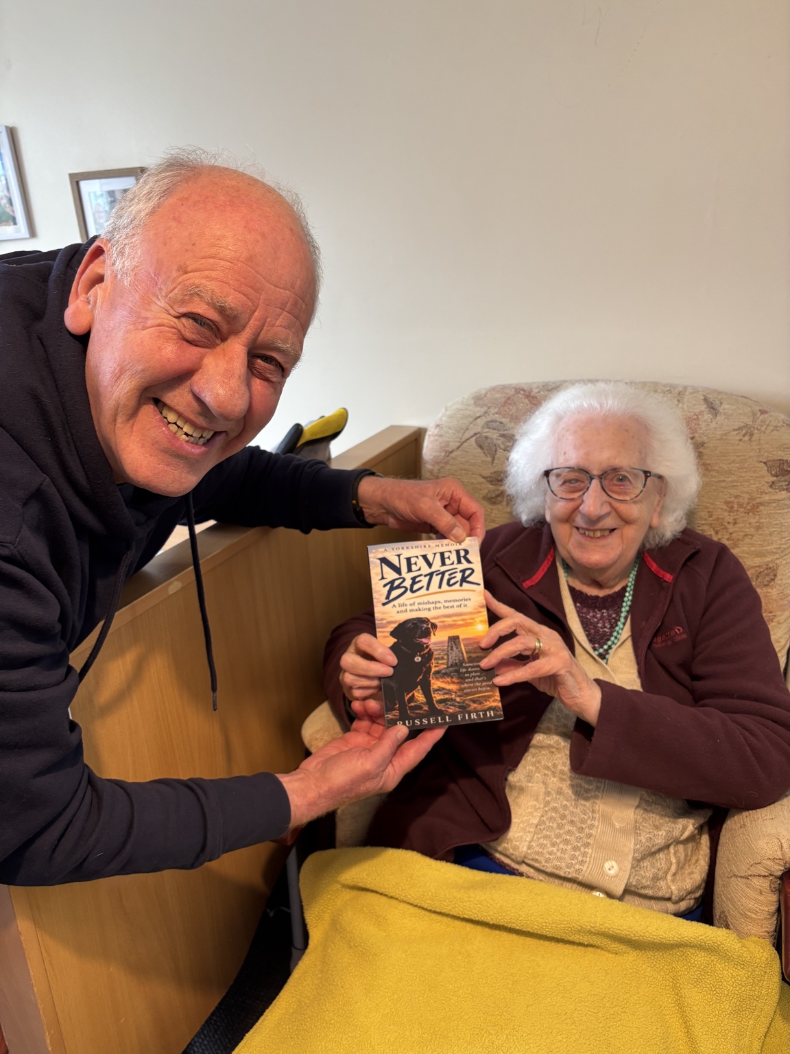 Russell Firth with his mother, who is holding his book Never Better
